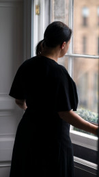 woman looking outside a sash window